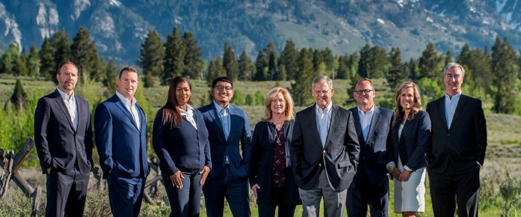 Business Development Officers in front of mountain